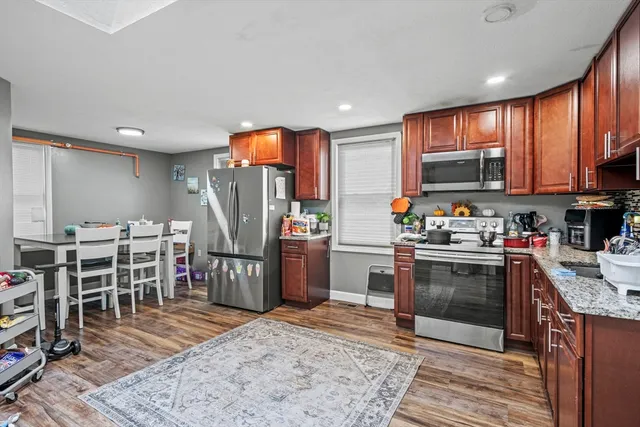 a kitchen with stainless steel appliances granite countertop a refrigerator stove and oven