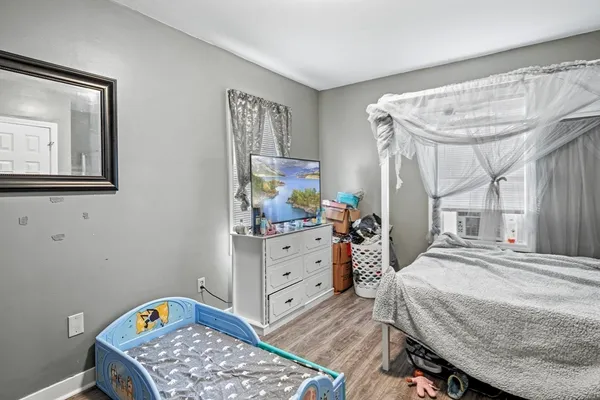 a bedroom with a bed and a dresser in it