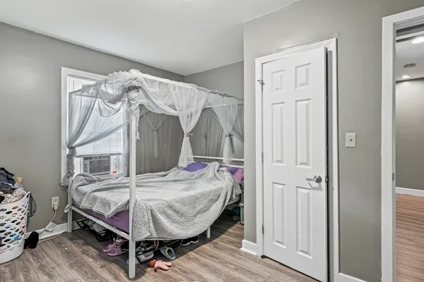 a bedroom with bed and a window