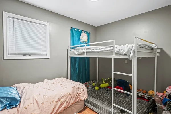 a bed sitting in a bedroom next to a window