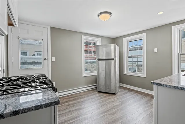 a kitchen with a refrigerator and a stove