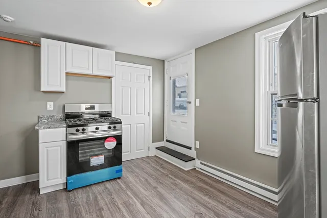 a kitchen with stainless steel appliances a stove a refrigerator and cabinets
