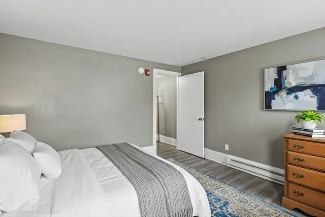 a bedroom with a bed and a dresser in it