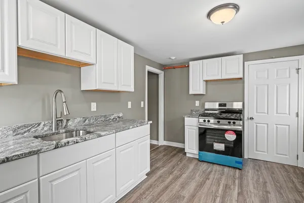 a kitchen with stainless steel appliances granite countertop a stove a sink and a refrigerator