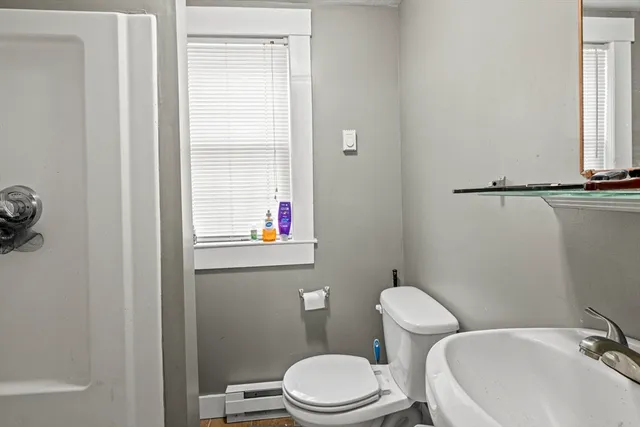 a white toilet sitting next to a bathroom sink