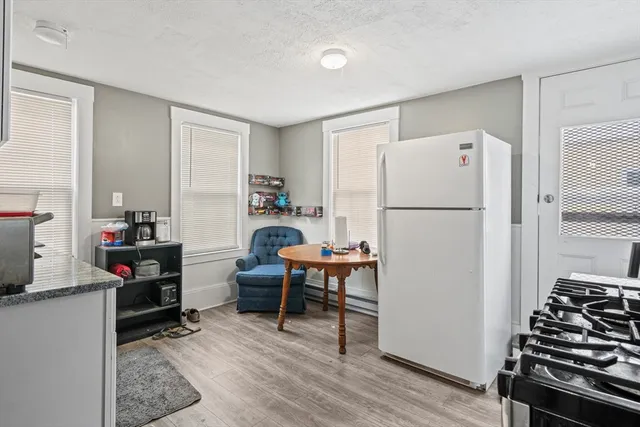 a kitchen with stainless steel appliances a refrigerator and a stove top oven