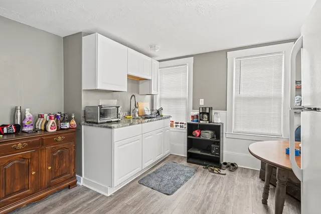 a kitchen with a refrigerator and a stove top oven