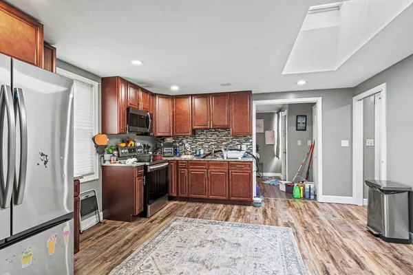 a kitchen with stainless steel appliances granite countertop a refrigerator stove and oven