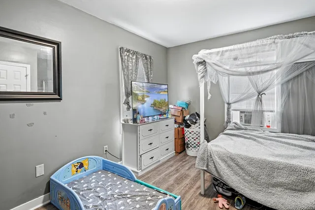 a bedroom with a bed and a dresser in it