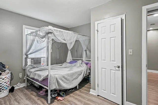 a bedroom with a bed and a mirror