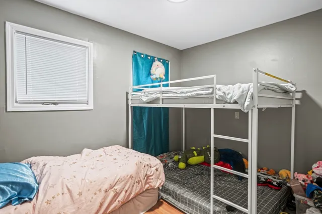 a bed sitting in a bedroom next to a window