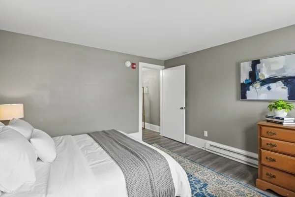 a bedroom with a bed and a dresser in it