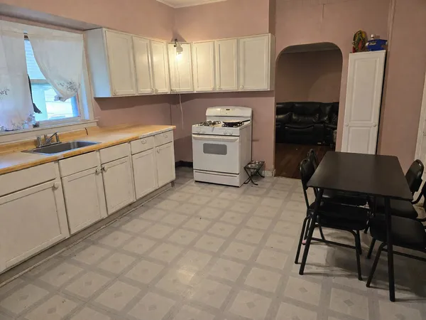 a kitchen with a stove a sink and a refrigerator