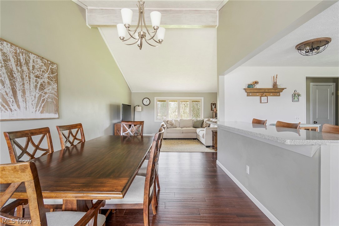 8370 Herbert Road Canfield, OH 44406 - Photo 36 of 48 Dining space with an inviting chandelier, dark hardwood / wood-style floors, high vaulted ceiling, and beamed ceiling