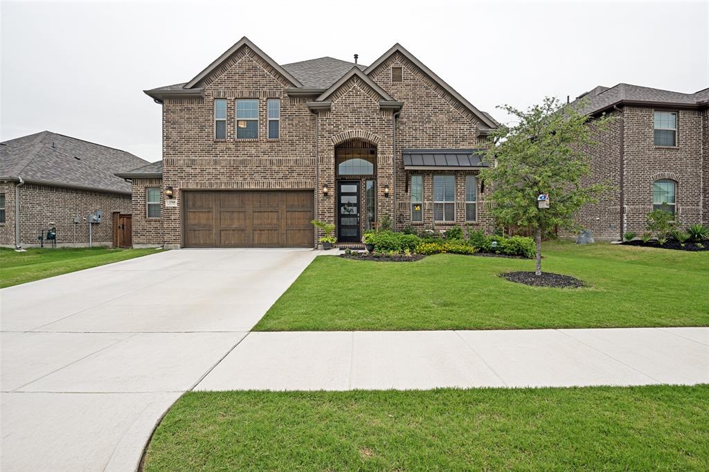 2508 Henley Way Mansfield, TX 76084 - Photo 1 of 25 a front view of a house with a yard and garage