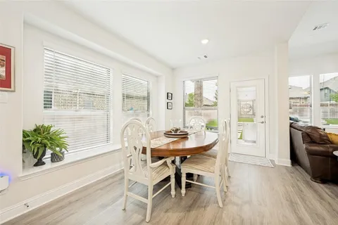 a dining room with furniture and wooden floor