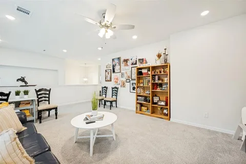 a room with furniture a rug and a book shelf