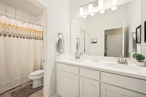 a bathroom with a toilet a sink and a mirror