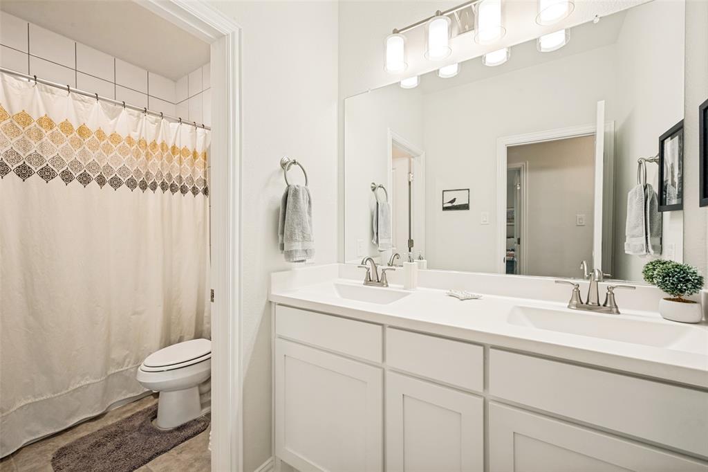 2508 Henley Way Mansfield, TX 76084 - Photo 17 of 25 a bathroom with a toilet a sink and a mirror
