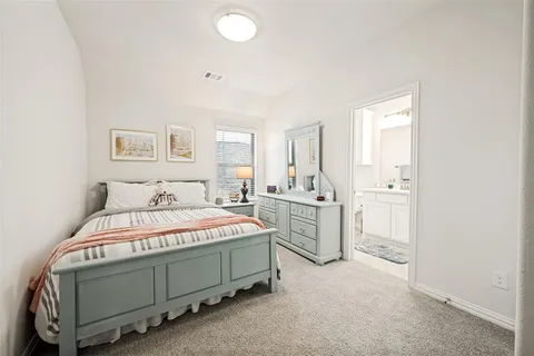 a bedroom with bed and a window