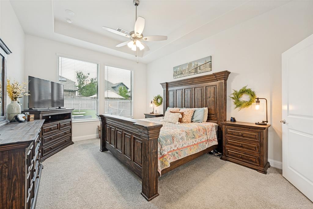 2508 Henley Way Mansfield, TX 76084 - Photo 21 of 25 a bed room with a bed dresser and a flat tv screen