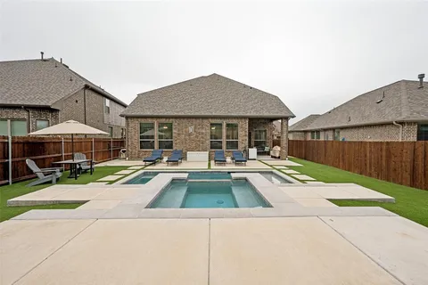 a view of a house with backyard porch and sitting area