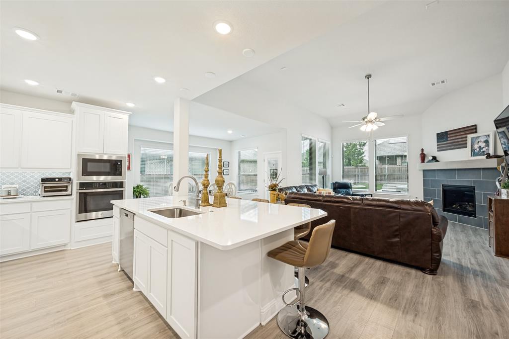 2508 Henley Way Mansfield, TX 76084 - Photo 10 of 25 a large white kitchen with a large island in the center
