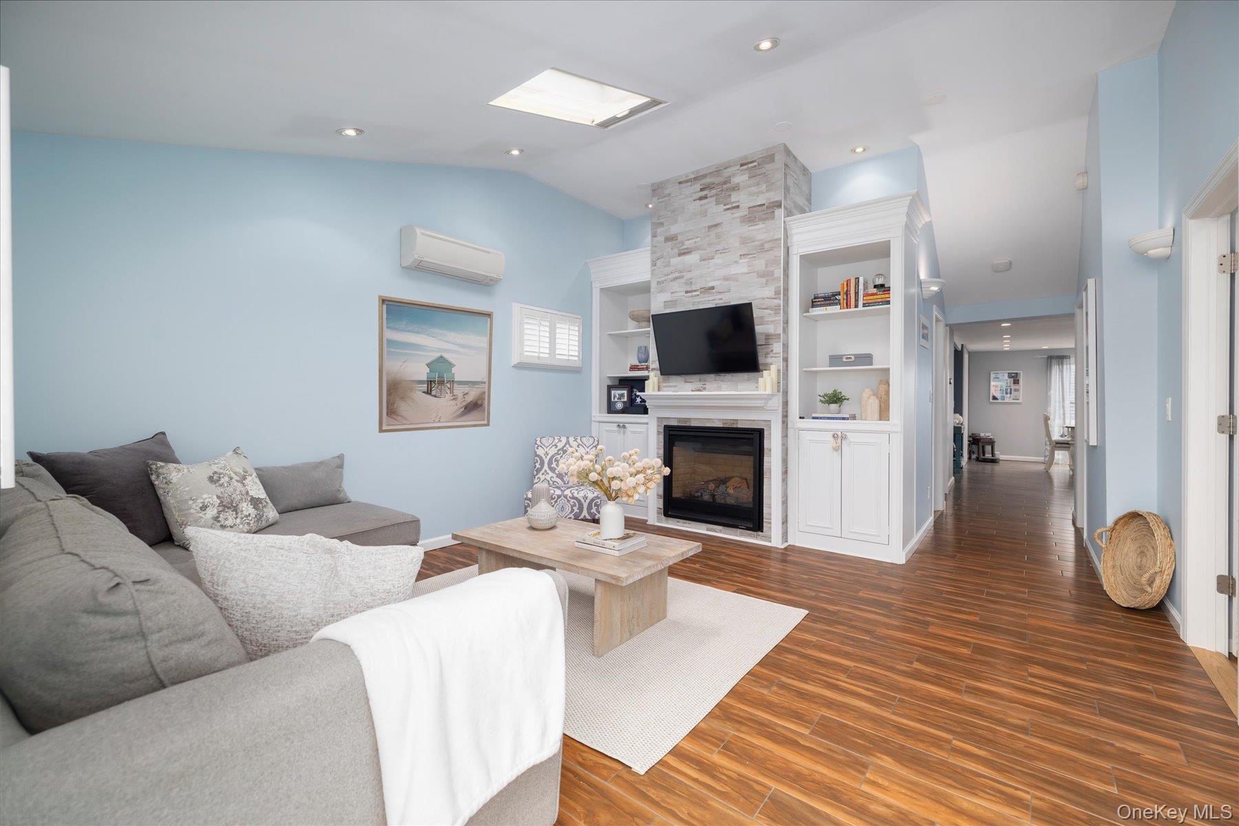 35 Nebraska Street Long Beach, NY 11561 - Photo 2 of 24 Open Living Room with Custom Built-Ins Surrounding A Gas Fireplace.