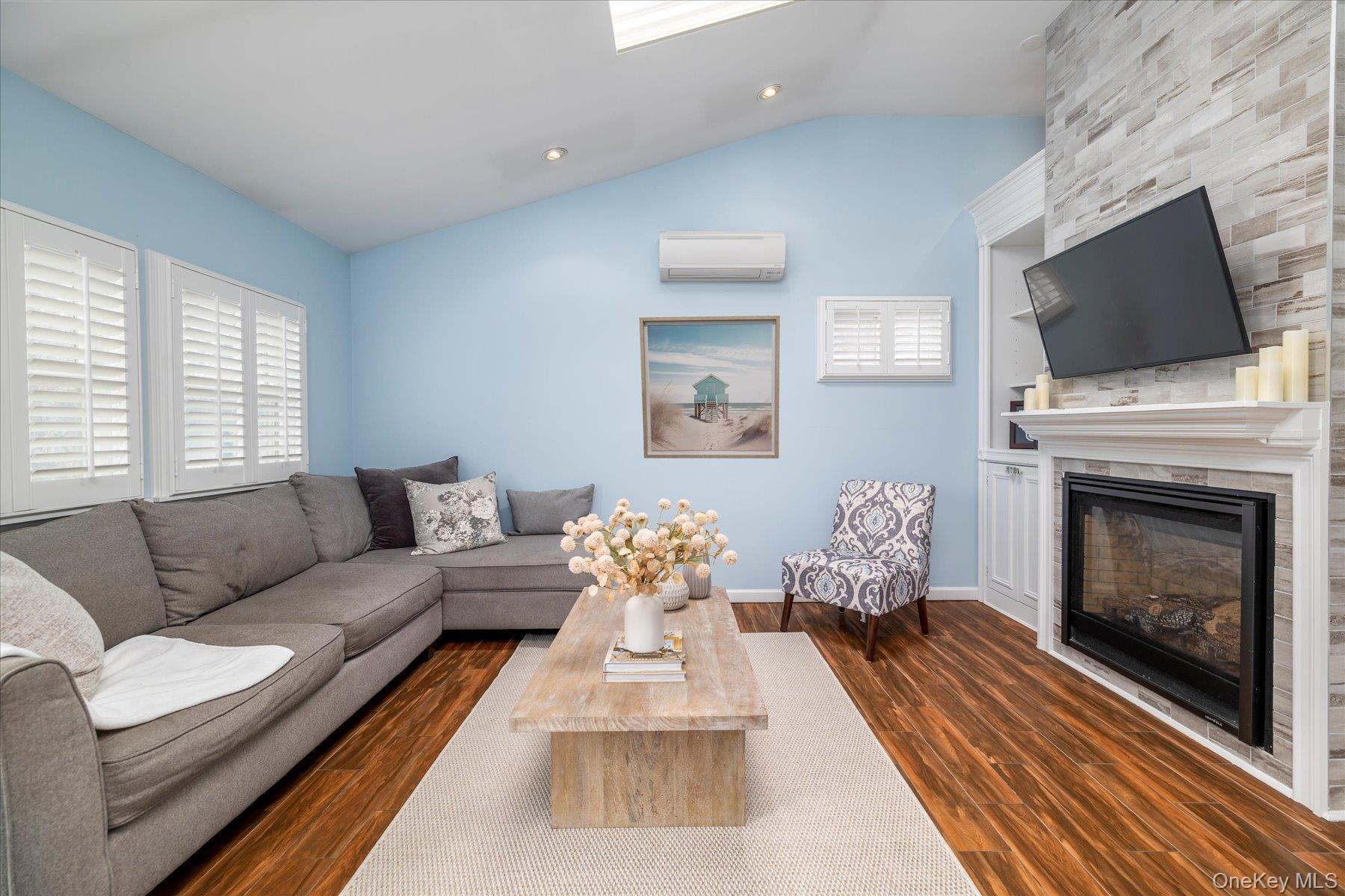 35 Nebraska Street Long Beach, NY 11561 - Photo 3 of 24 Open Living Room with Gas Fireplace and Custom Built-ins, Vaulted Ceilings and a Skylight