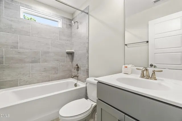a bathroom with a sink mirror toilet and bathtub
