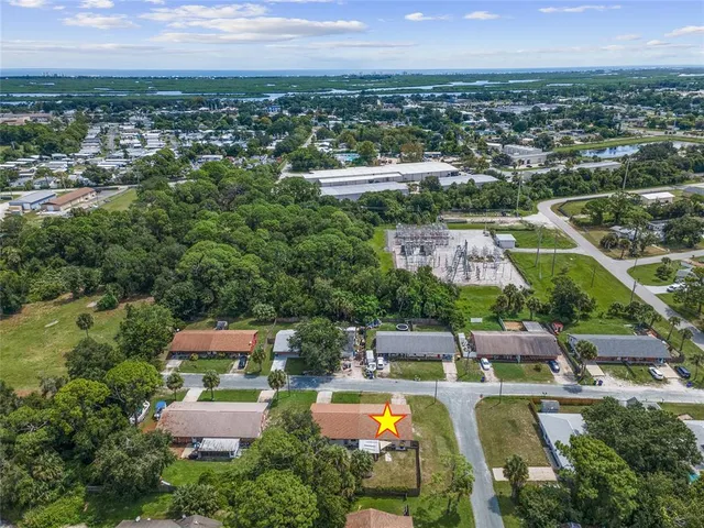an aerial view of residential houses with outdoor space and street view