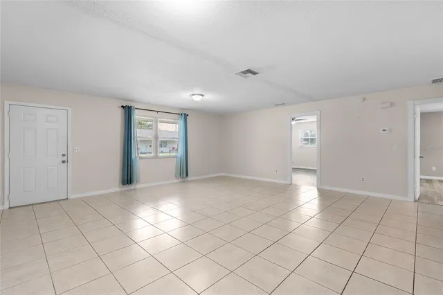 a large white kitchen with a sink a stove and a refrigerator