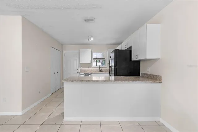 a kitchen with stainless steel appliances granite countertop a sink stove and microwave