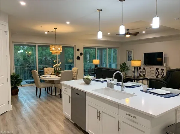 a kitchen with a sink and a large window appliances