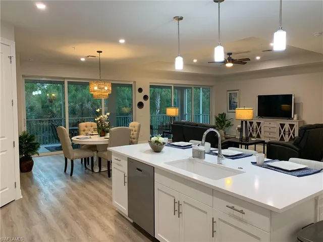 a kitchen with a sink and a large window appliances