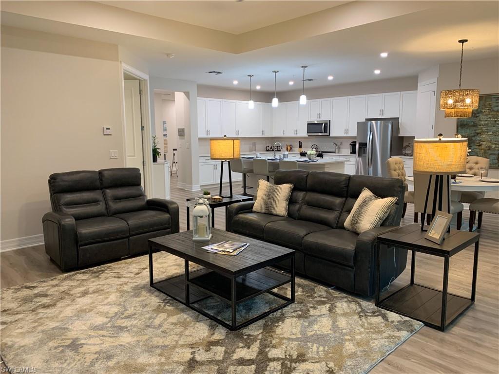208 Indies Drive East, Unit 202 Naples, FL 34114 - Photo 11 of 48 a living room with furniture and kitchen view