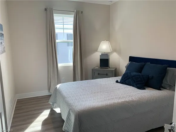 a bedroom with a bed and a lamp