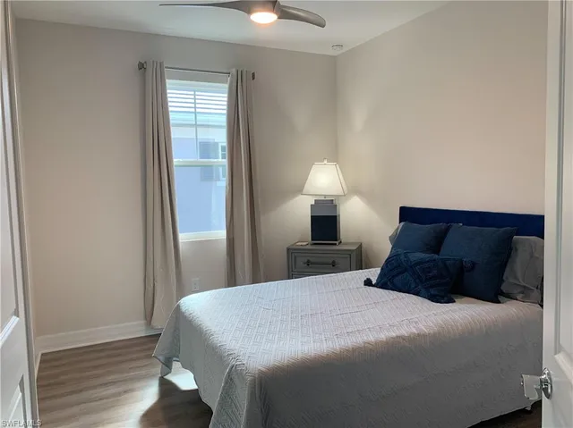 a bedroom with a bed and a night stand