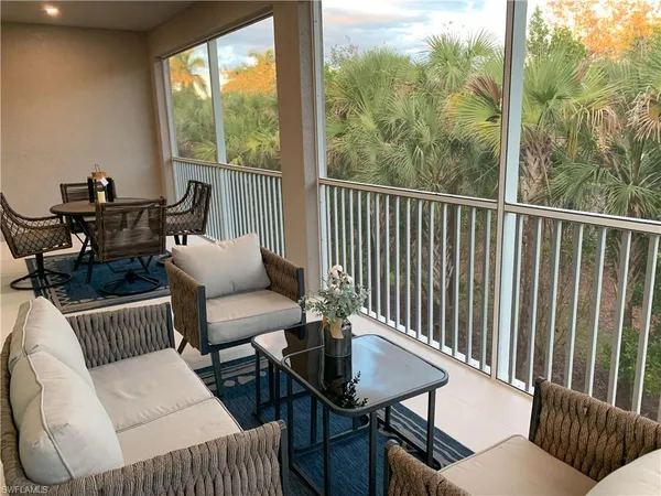 a balcony with furniture and a potted plant