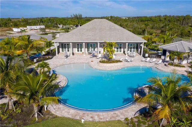 a view of a house with swimming pool and sitting area