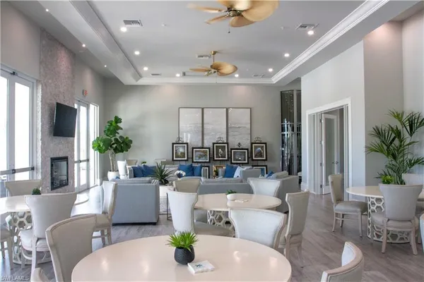 a living room with furniture potted plant and a chandelier