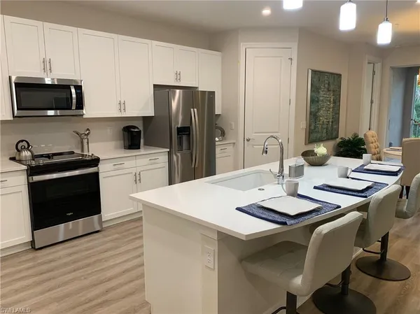 a kitchen with a sink a stove and refrigerator