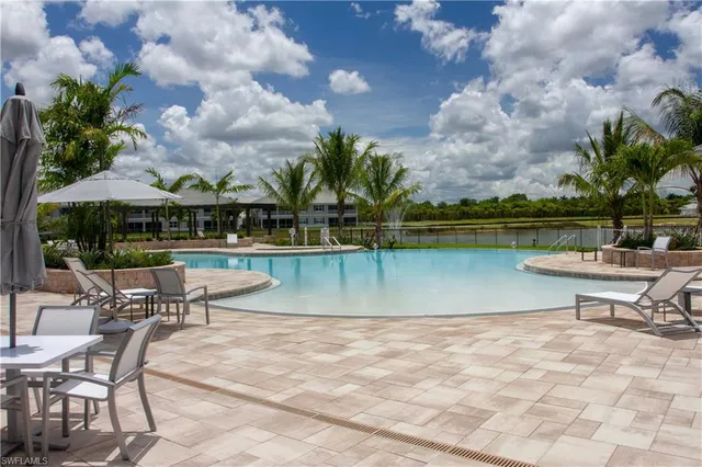 a view of a lake with a table and chairs