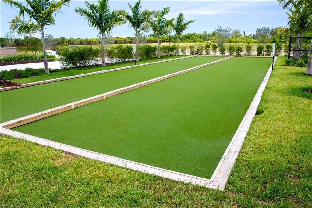 208 Indies Drive East, Unit 202 Naples, FL 34114 - Photo 48 of 48 a view of a golf course with a lake