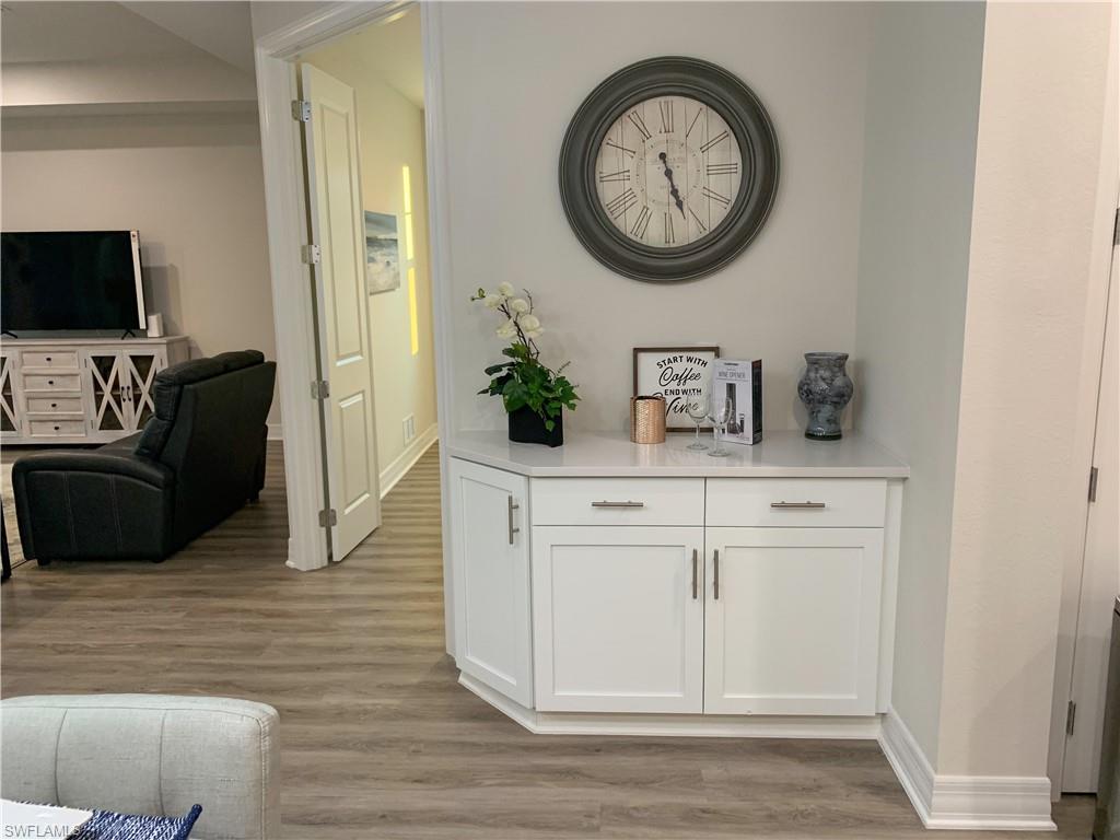 208 Indies Drive East, Unit 202 Naples, FL 34114 - Photo 7 of 48 a living room with furniture and a flat screen tv