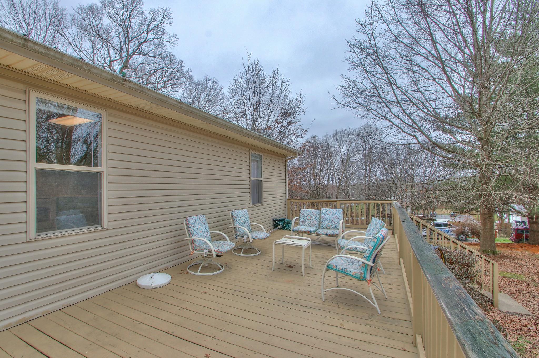 1006 Richland Trail Road Ashland City, TN 37015 - Photo 27 of 33 a view of a deck with chairs and wooden floor