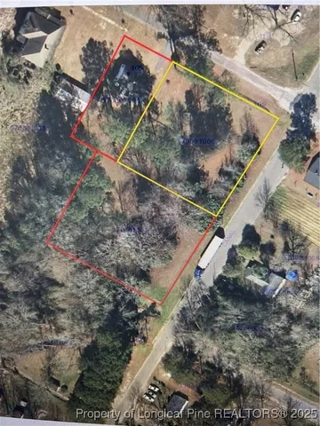 a view of a yard with wooden fence