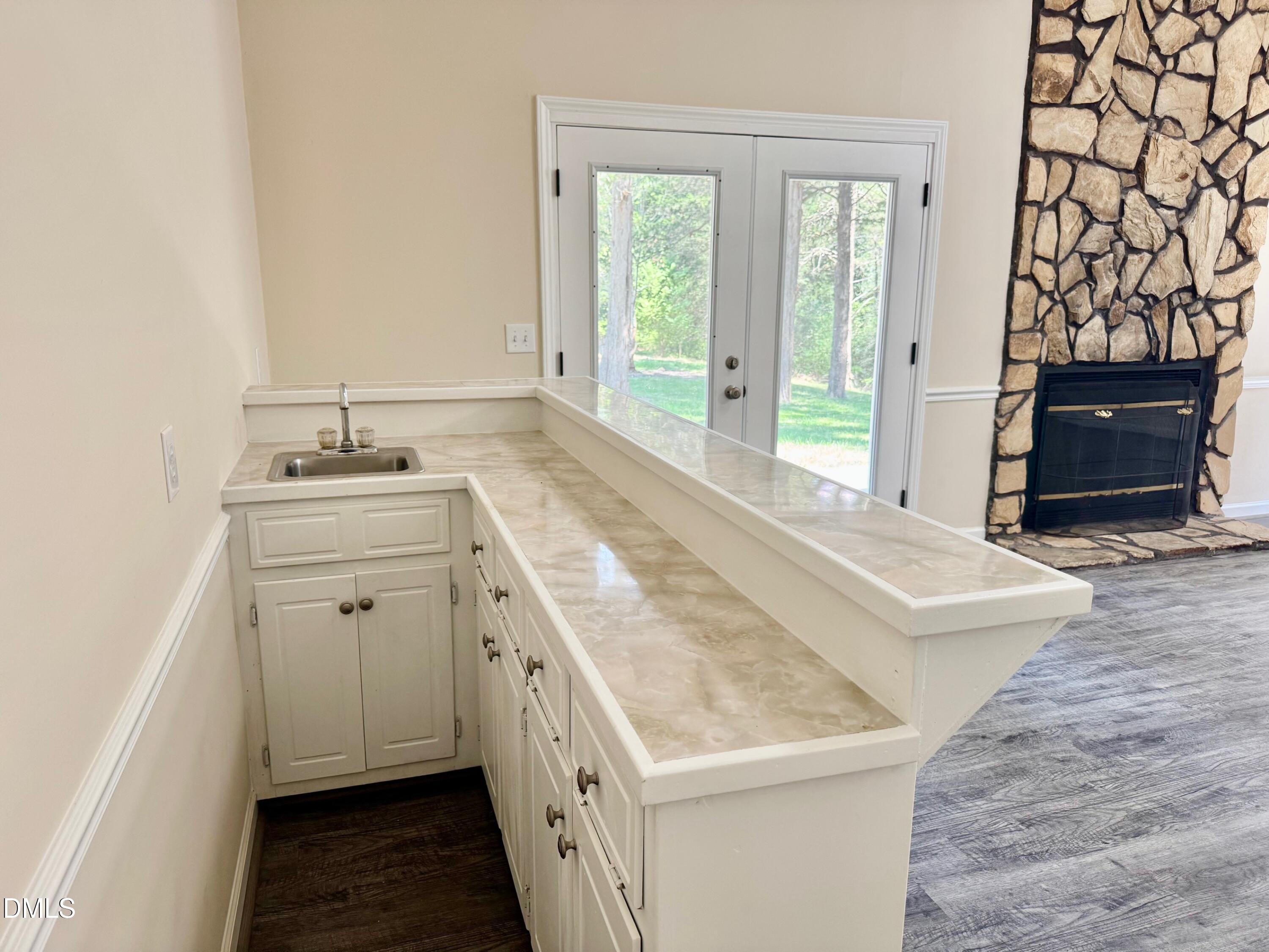 1720 Ross Mill Road Henderson, NC 27537 - Photo 13 of 42 a bathroom with a granite countertop sink a mirror and a bathtub