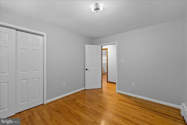 a view of an empty room and wooden floor