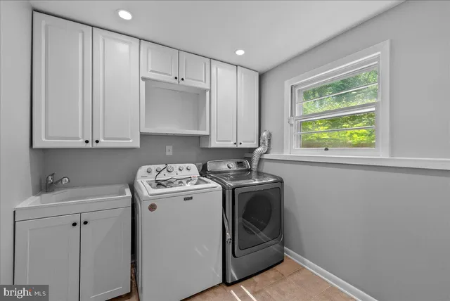 a view of a storage and utility room with washer and dryer
